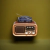 Brown vintage portable radio with solar panel and antenna, an old-fashioned rechargeable outdoor radio Application Scenario
